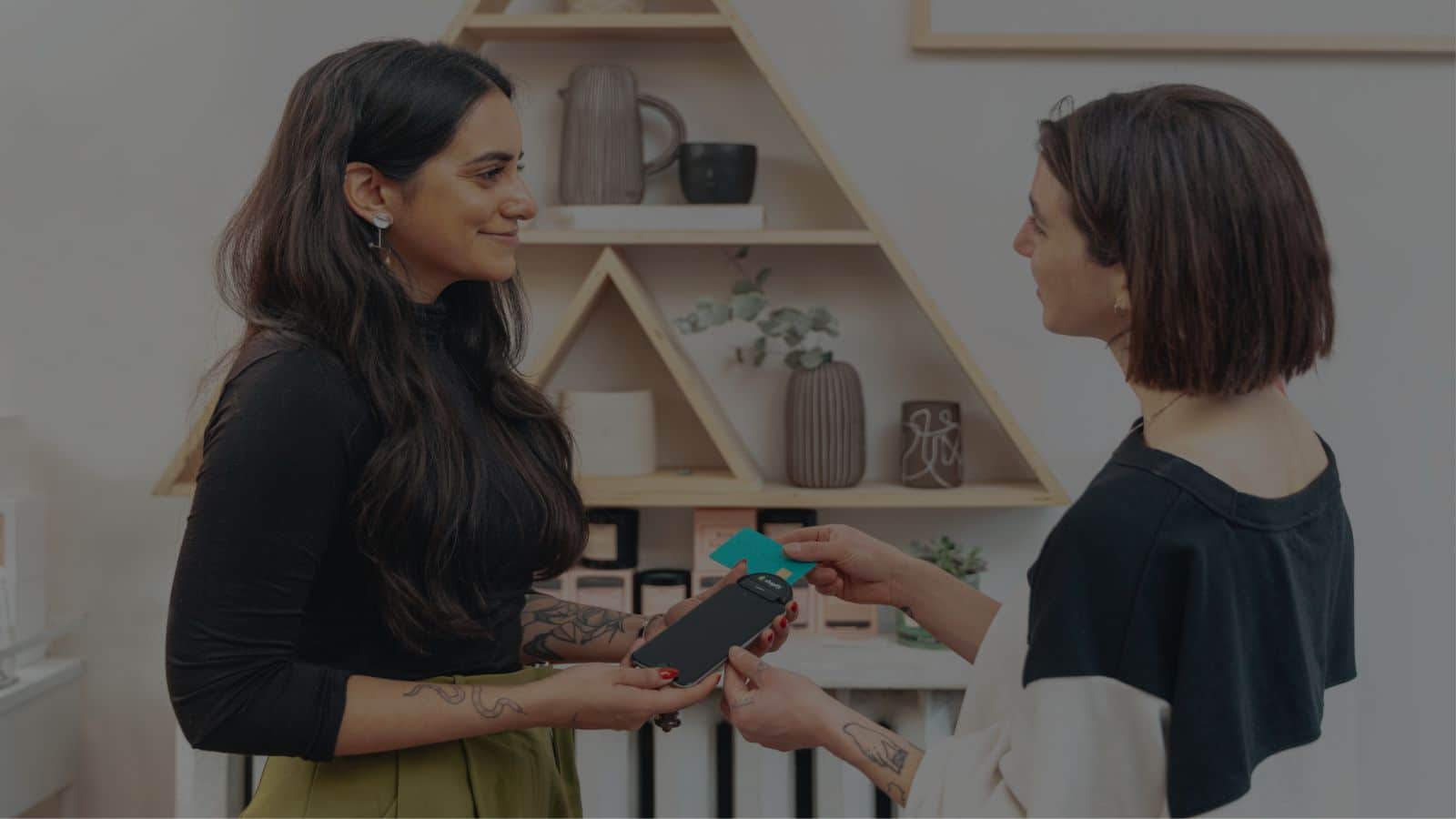 woman giving business gift to another lady
